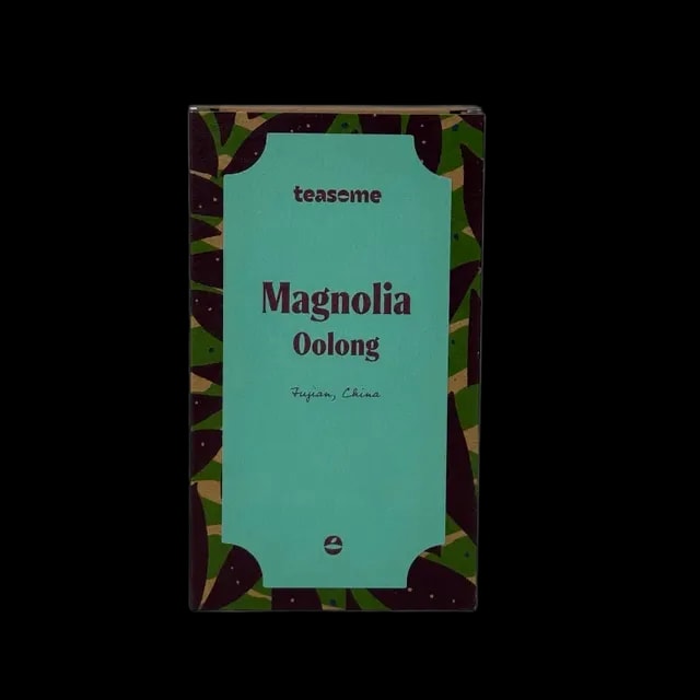 Opakowanie herbaty oolong Teasome Magnolia Oolong 50 g z miętową etykietą na tle w roślinne wzory, dostępne w sklepie z kawą i herbatą